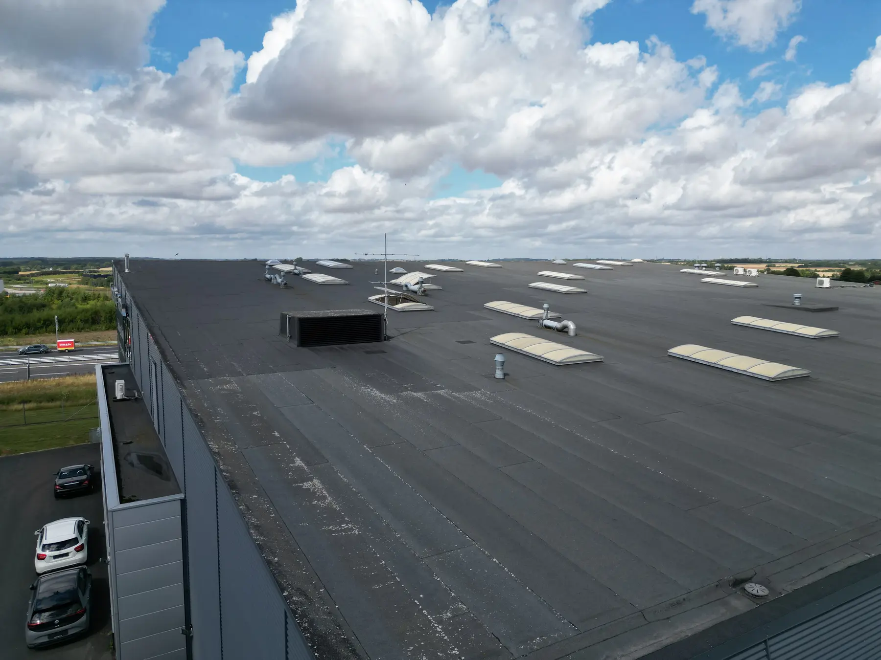 An aerial view across a commercial property and the surrounding landscape, photographed during ACED Miljø’s fieldwork.